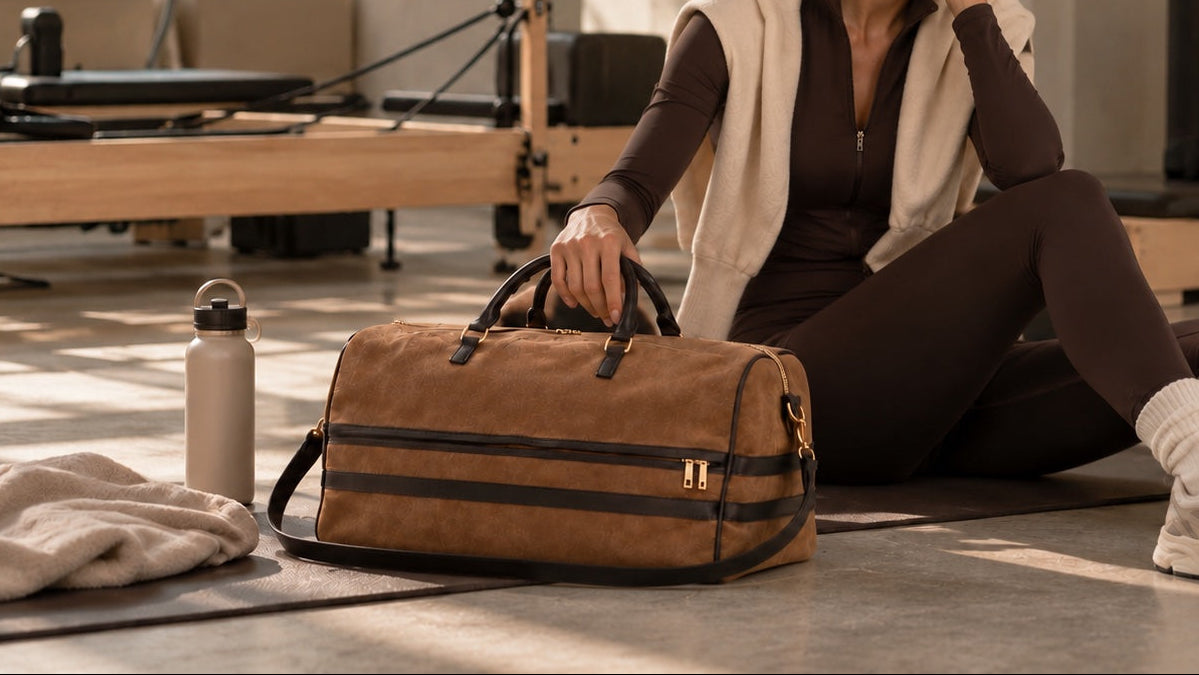 Cognac suede travel bag with dark brown leather details and gold-tone hardware