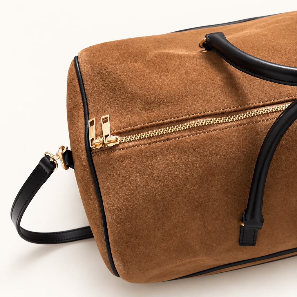 Cognac suede travel bag with dark brown leather details and gold-tone hardware