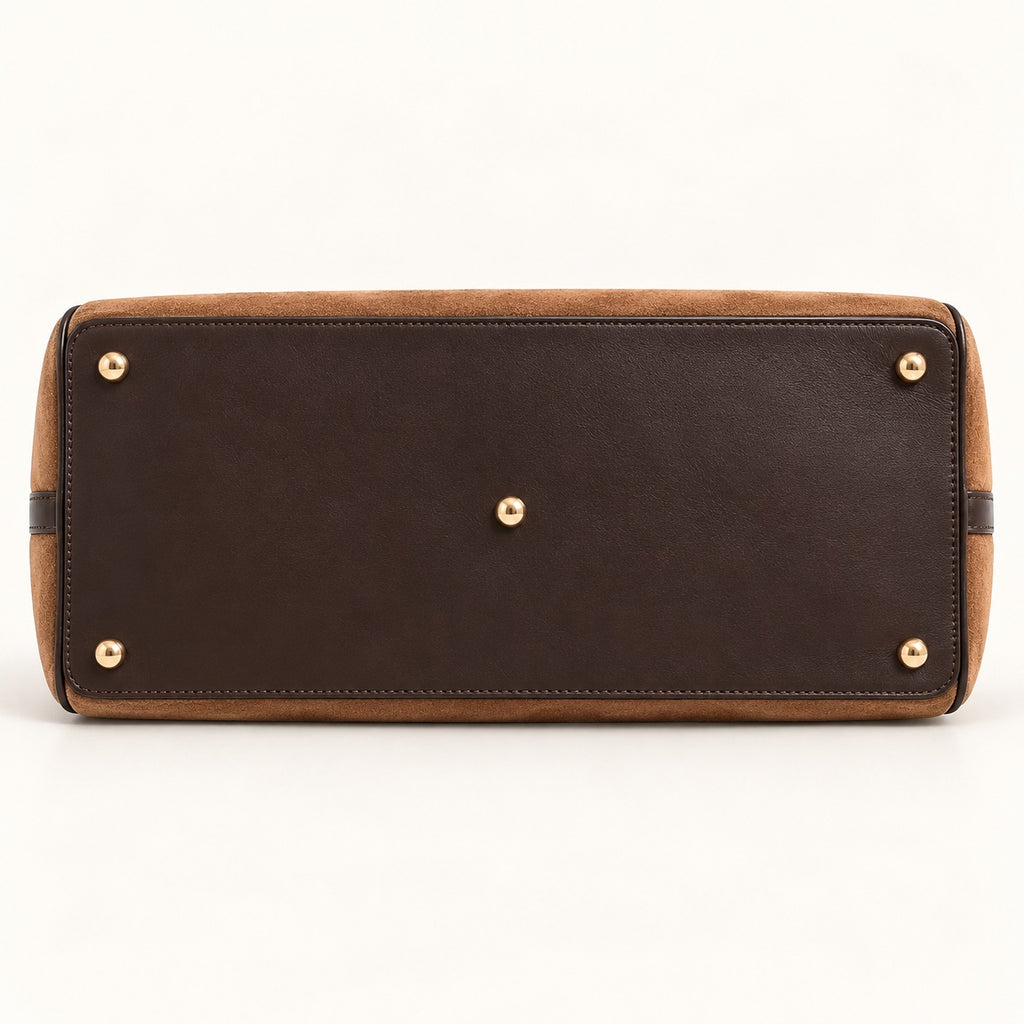 Cognac suede travel bag with dark brown leather details and gold-tone hardware
